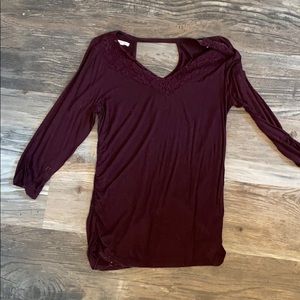 Woman’s maroon lacy top